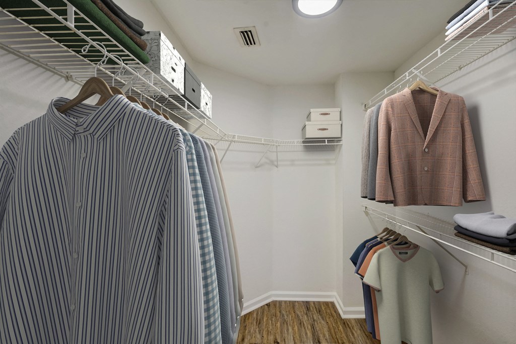a closet with a rack of clothes and a shirt hanging on a rack