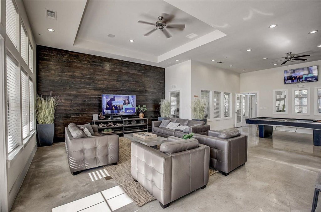 a large living room with couches and a television