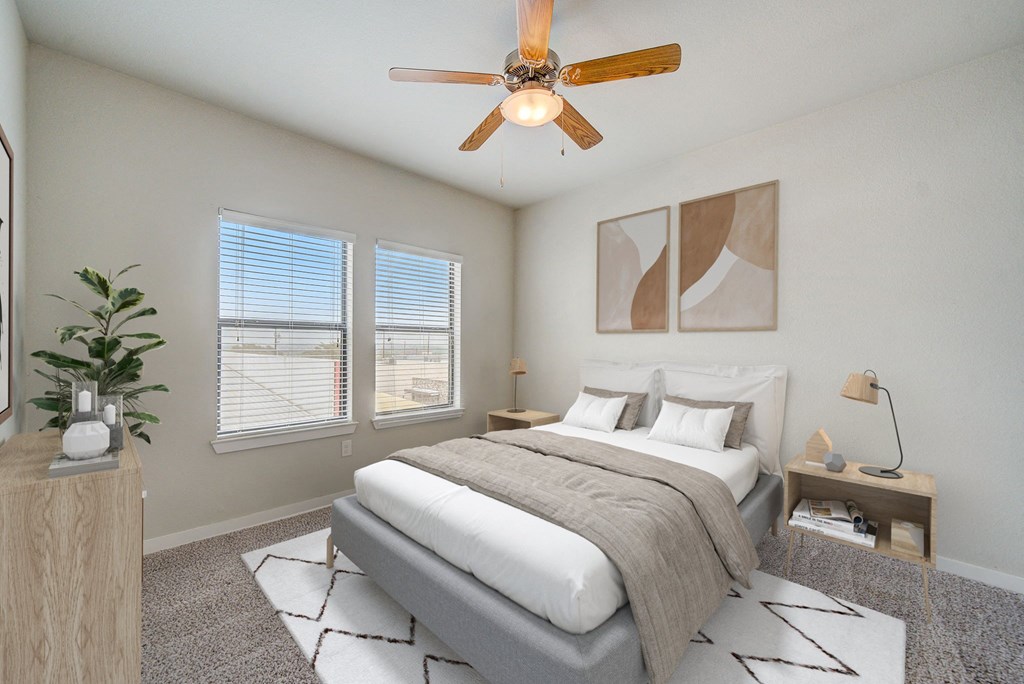 a bedroom with a large bed and a ceiling fan