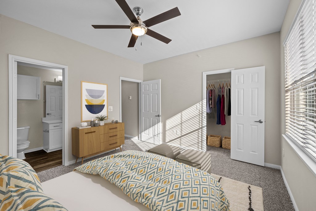 a bedroom with a large bed and a ceiling fan