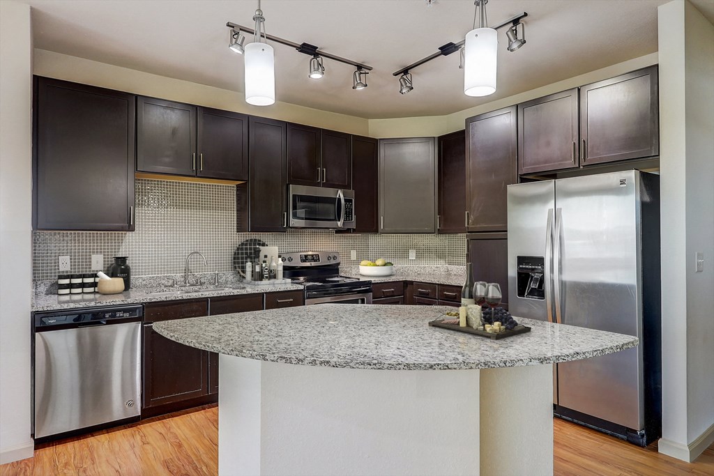 a kitchen with stainless steel appliances and granite counter tops