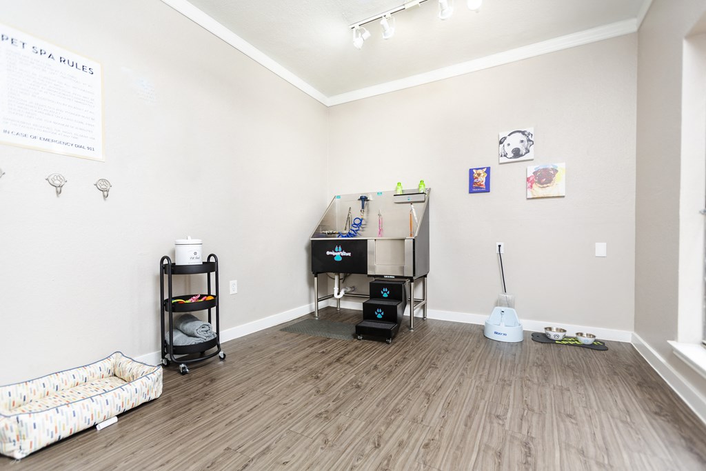 a living room with a couch and a desk in a room with wood flooring
