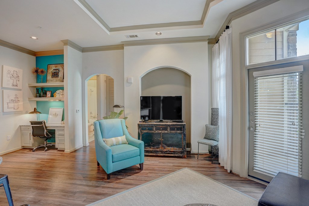 a living room with a fireplace and a blue chair