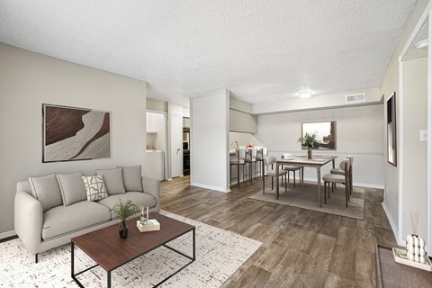 A living room with a grey couch and a coffee table.