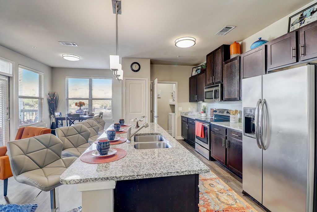 a kitchen with stainless steel appliances and a granite counter top