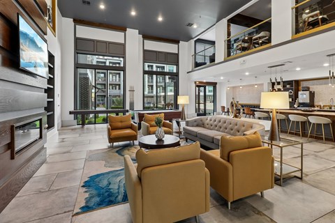 A modern living room with a large sofa, armchairs, and a coffee table.