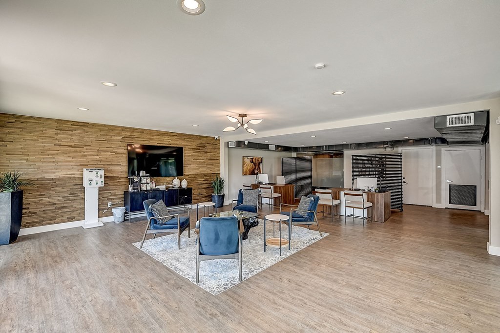 a resident clubhouse with wood flooring and a brick wall