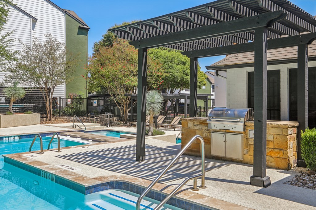 A pool with a slide and a hot tub.