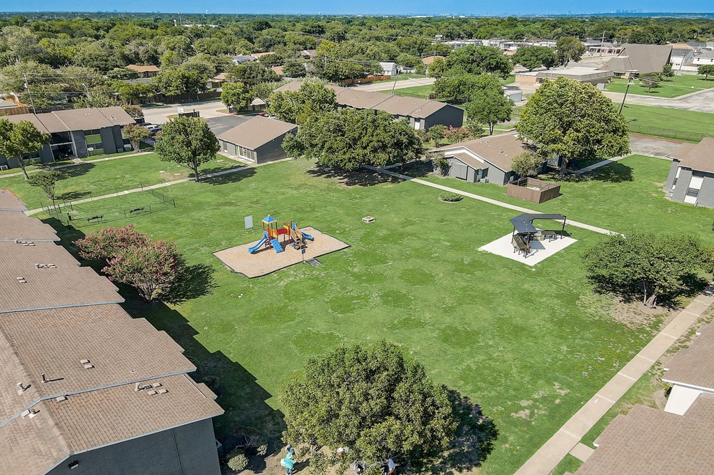 an aerial view of a backyard with a playground