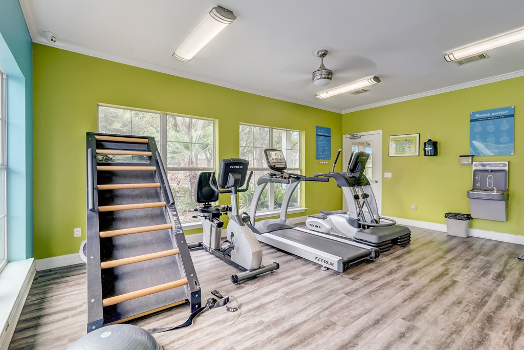 the gym with treadmills and weights at the commons on 54th