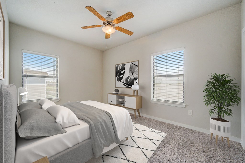 a bedroom with a bed and a ceiling fan