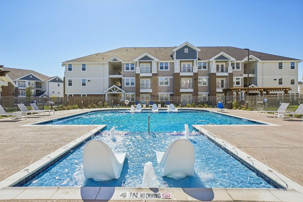 A pool with a white sculpture in the middle of it.