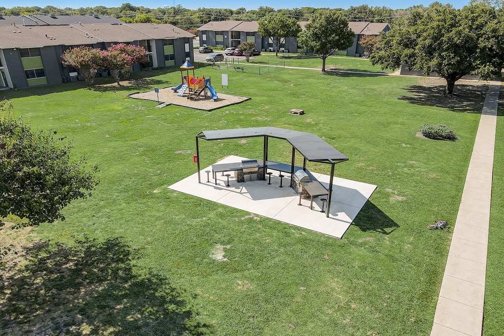 an aerial view of a backyard with a picnic table and a playground