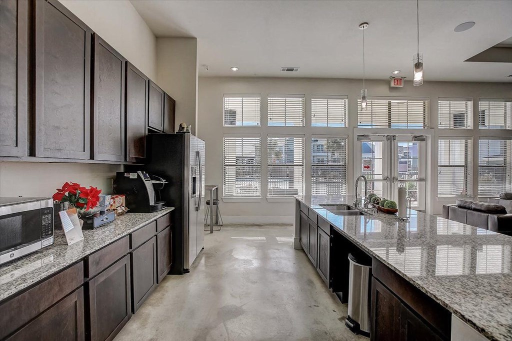 a large kitchen with an island and a large window