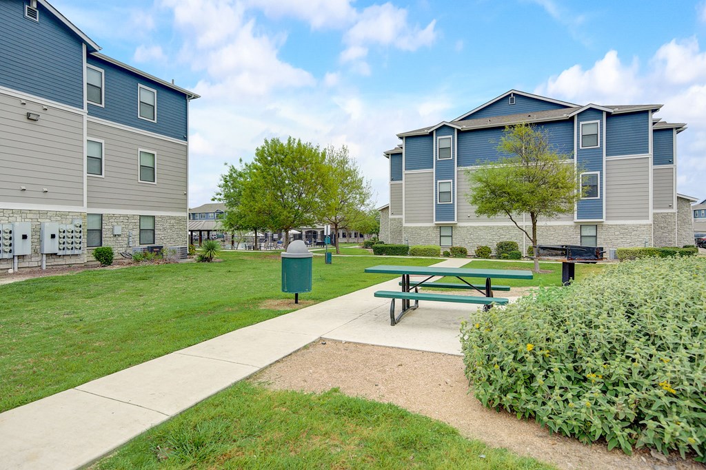 an image of a house with a fence and a picnic table