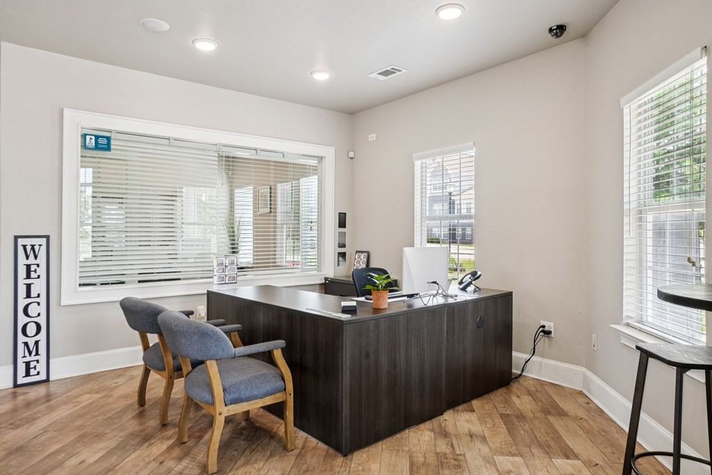 A reception area with a wooden desk and a blue chair.