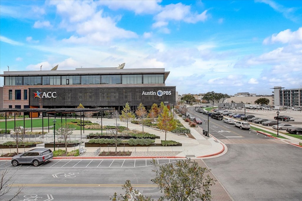 an aerial view of a building with cars parked in front of it