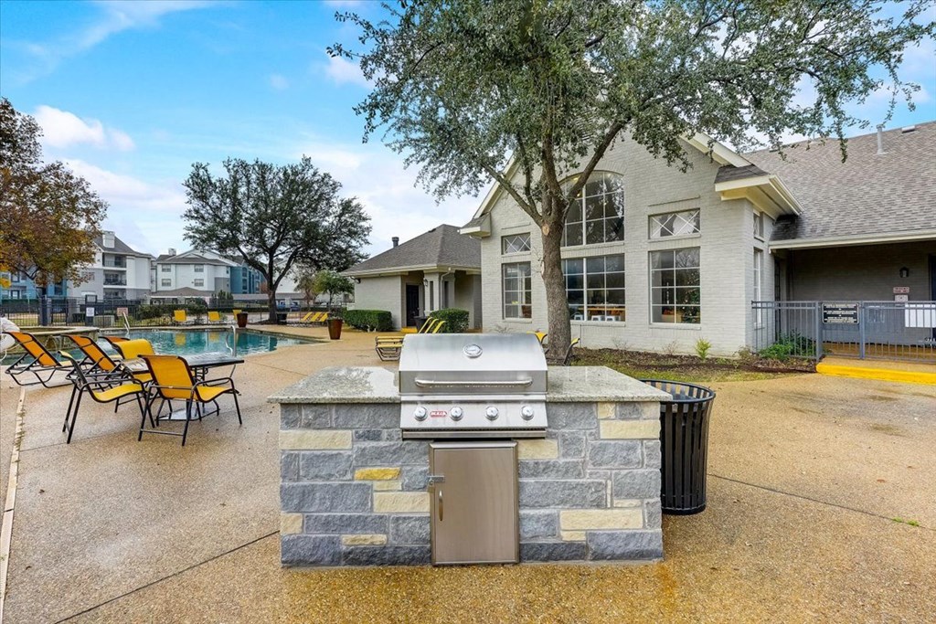 the preserve at ballantyne commons clubhouse with a gas grill and a swimming pool