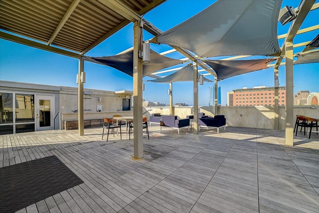 a roof patio with umbrellas on top of a building