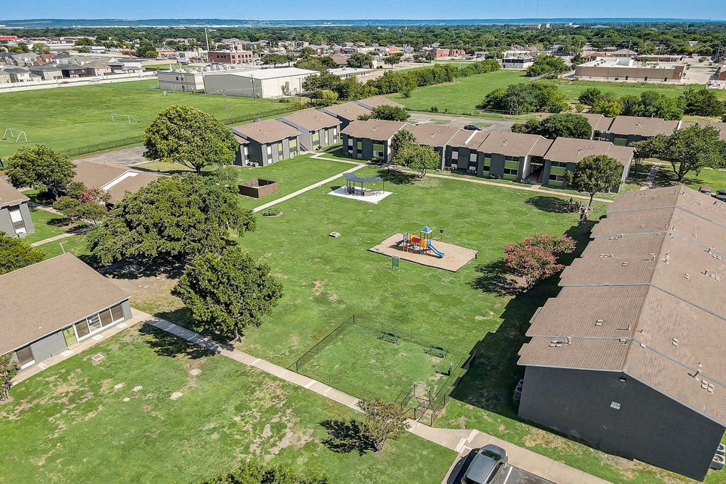 an aerial view of a backyard with a trampoline