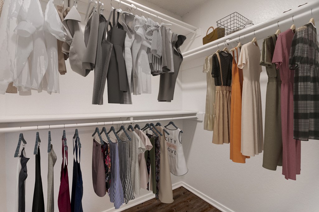 a closet with a rack of clothes hanging on the wall