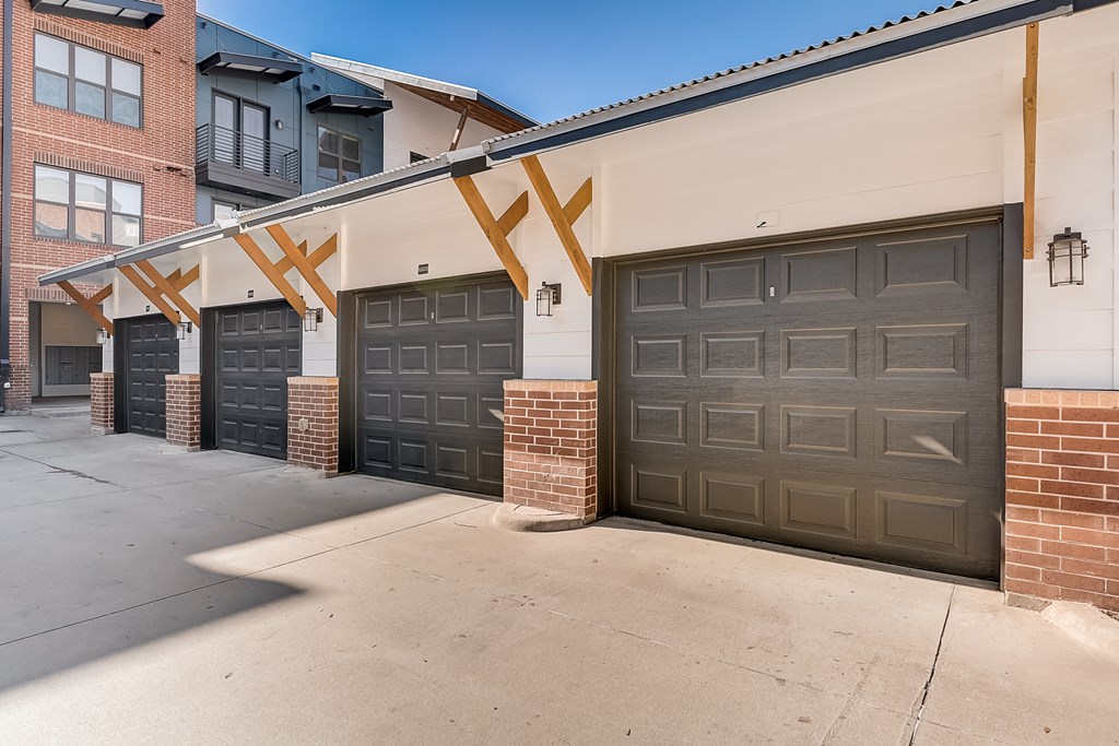 a garage door on the side of a building with black doors