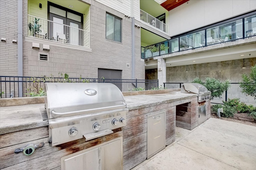a large outdoor kitchen with a grill and two grates