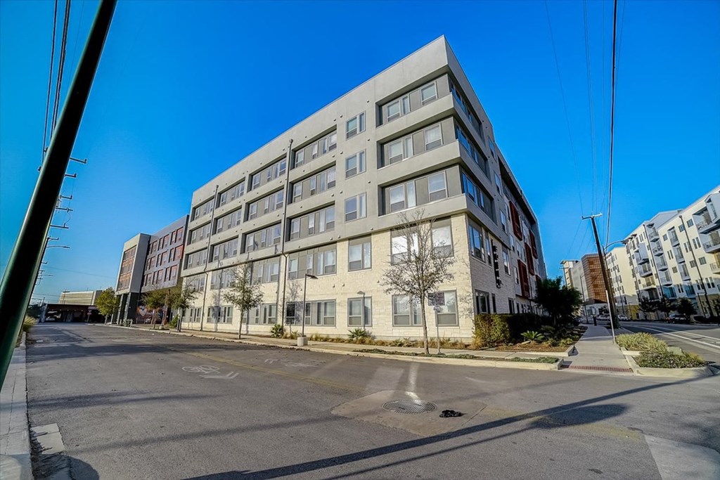 a large apartment building on the corner of a street