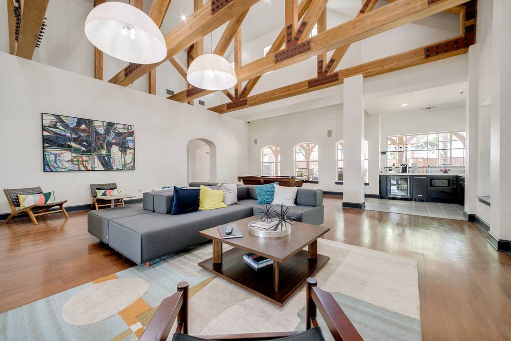 a living room with a gray couch and a wooden table