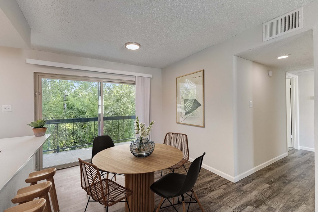 a dining room with a table and chairs