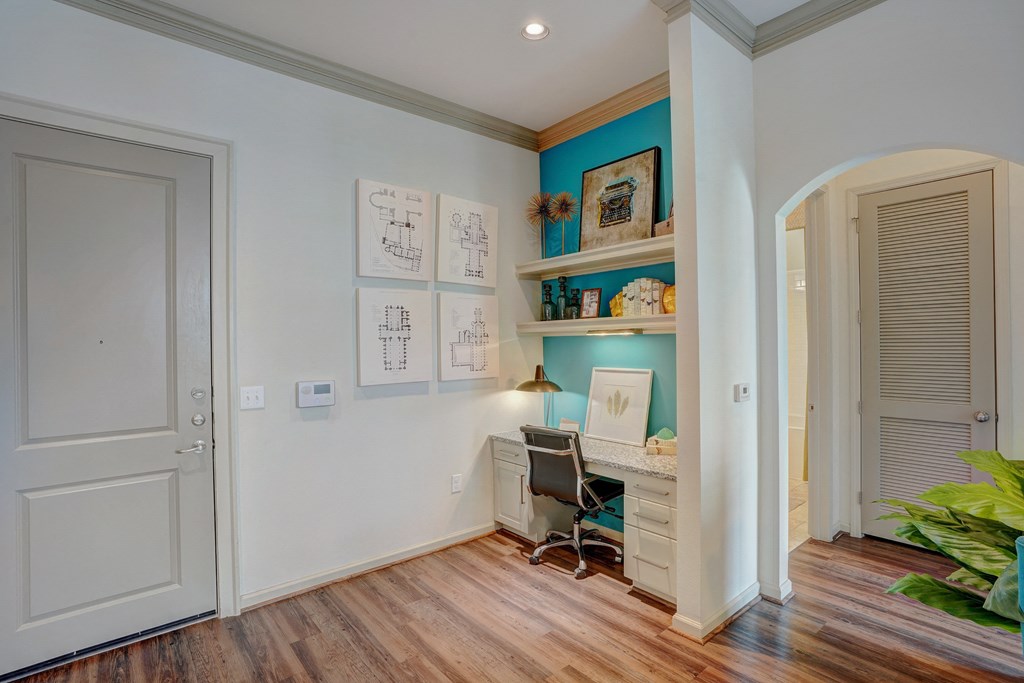 a home office with a desk and a chair