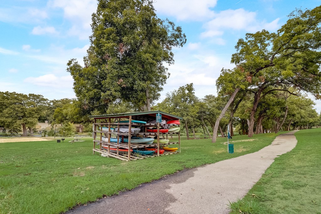 a kiosk in a park next to a path