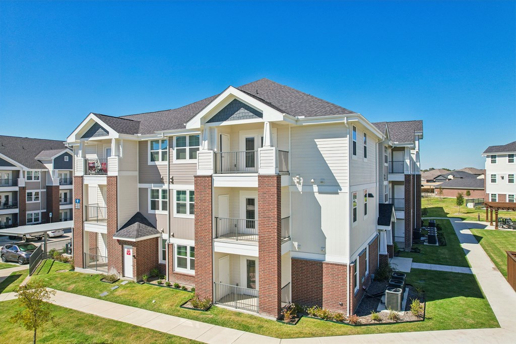 A large apartment complex with multiple buildings and balconies.