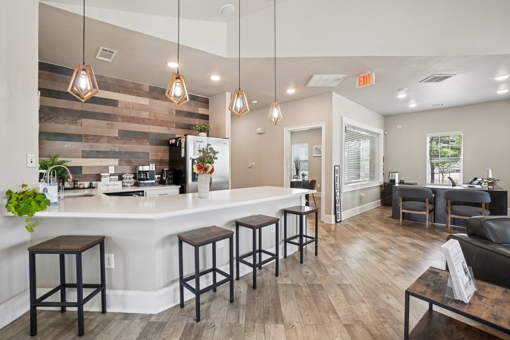 A kitchen with a bar area and a dining table.