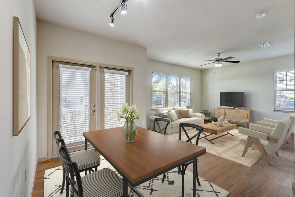 an open living room and dining room with a wooden table