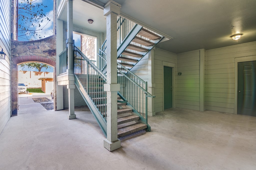 a spiral staircase on the second floor of a house with a door