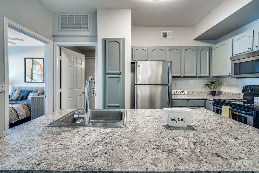 a kitchen with stainless steel appliances and granite counter tops