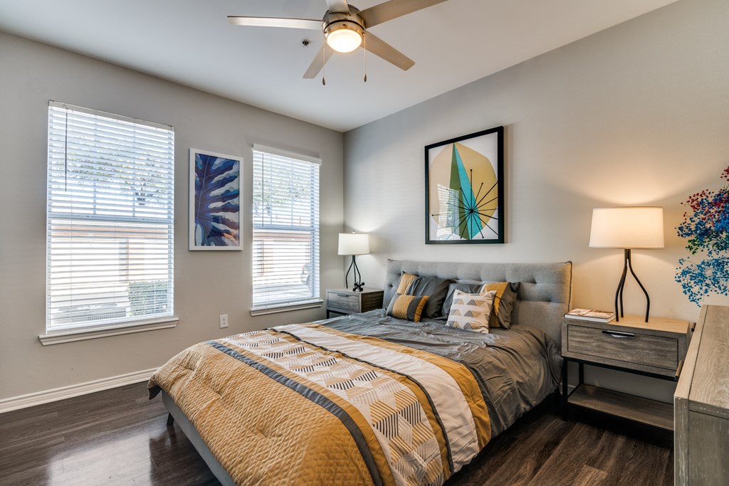 a bedroom with a large bed and a ceiling fan