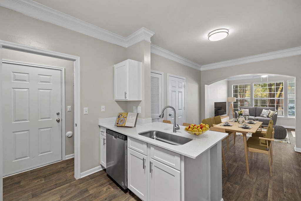 a kitchen and living room with a sink and a table
