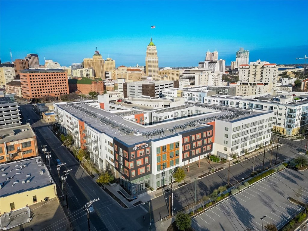 an aerial view of a building with a city in the background