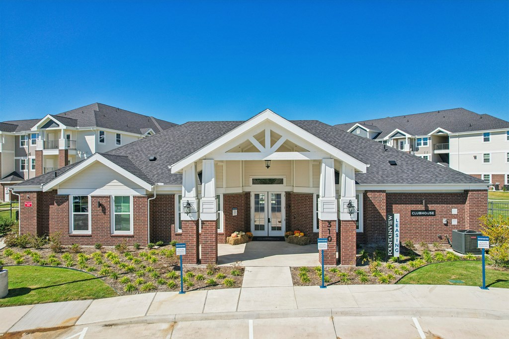 A large building with a white entrance and a sign that says "Welcome" in front of it.