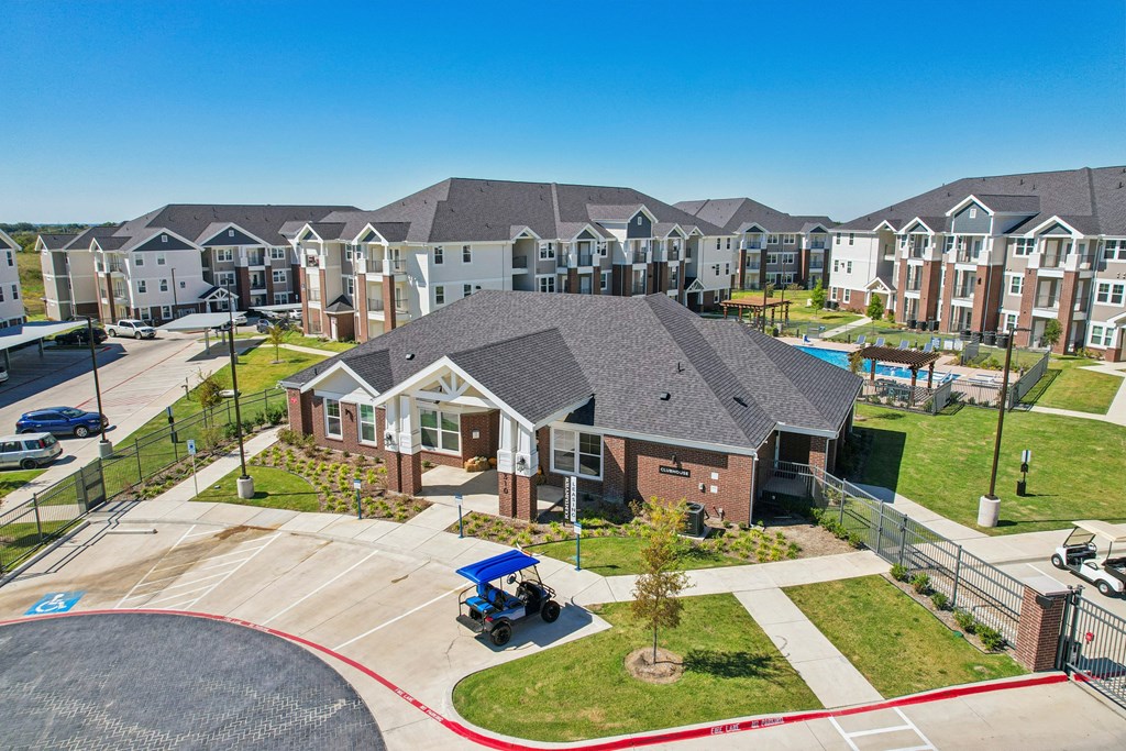 A residential area with houses and a blue lawnmower.