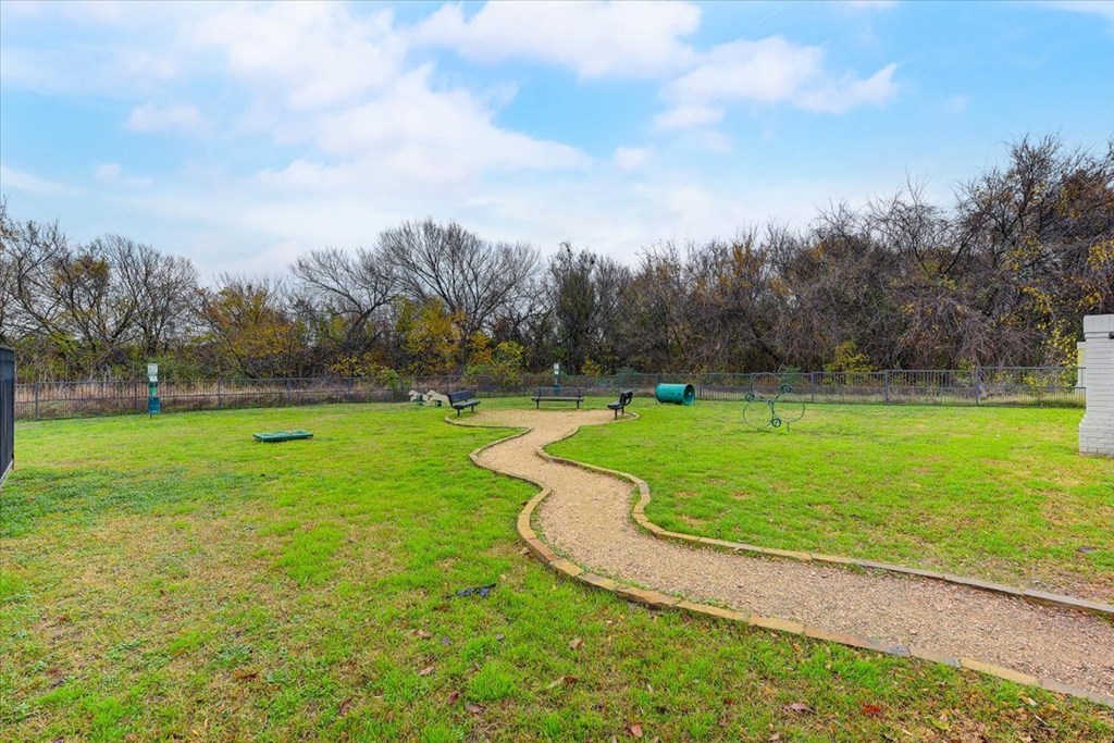 a park with a path in the middle of a field