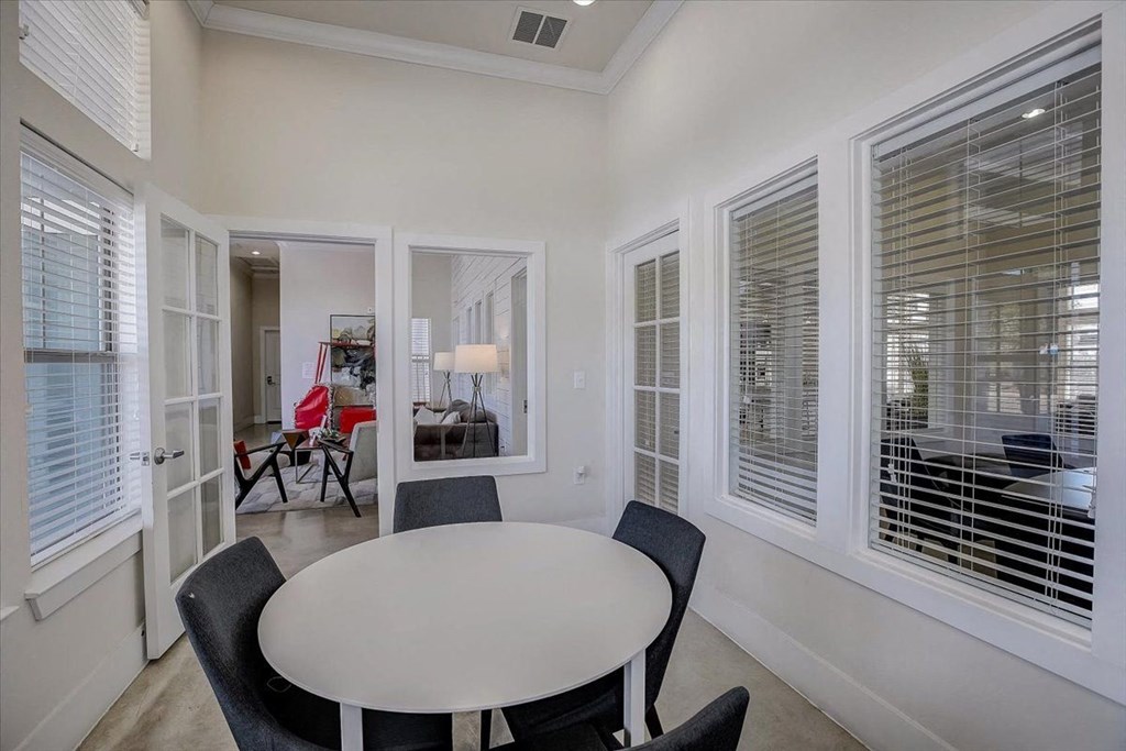 a dining room with a table and chairs