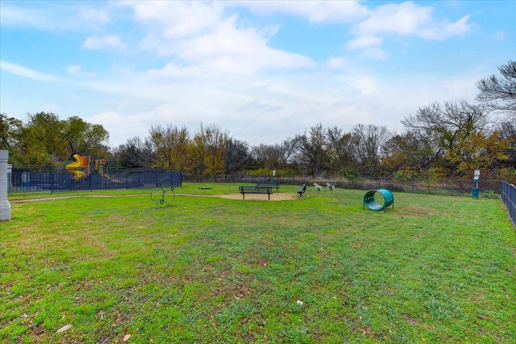 a backyard with a dog park and a playground