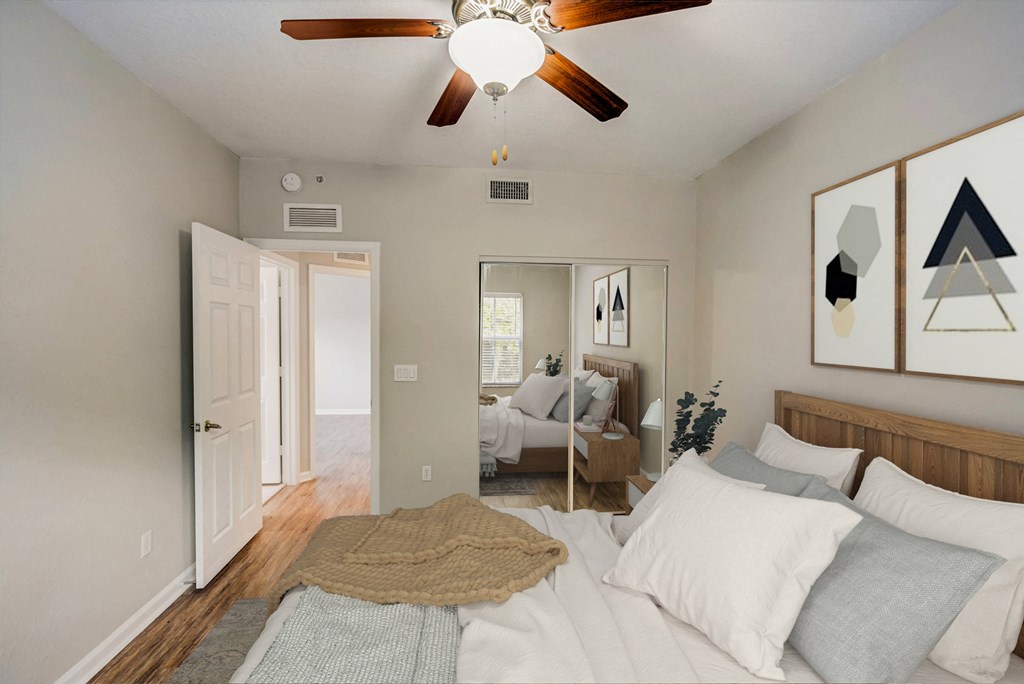 a bedroom with a bed and a ceiling fan