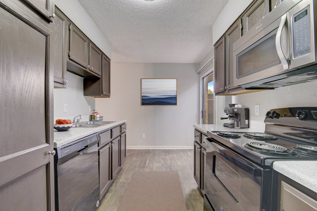 a kitchen with stainless steel appliances and stainless steel cabinets and a stainless steel stove top