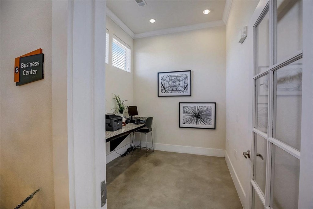 a room with a desk and a door and a window