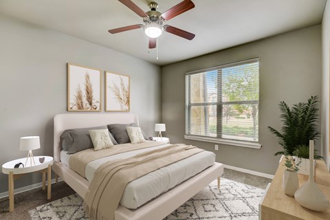 an empty bedroom with a ceiling fan and a bed