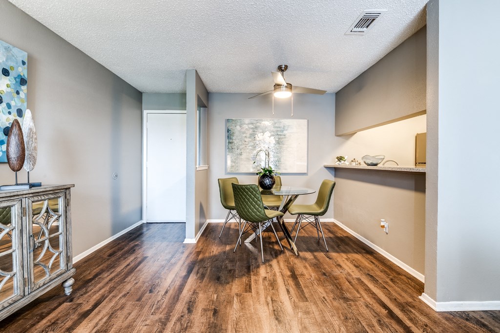 a dining room with a table and chairs and a window